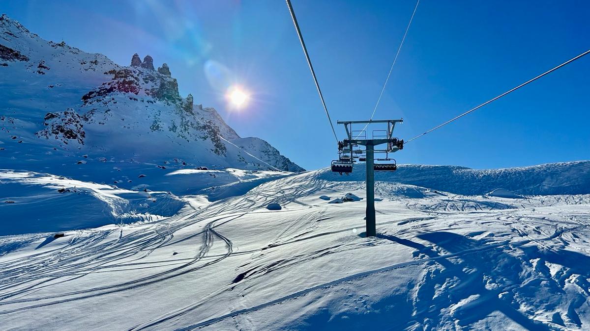 Corvatsch ski resort mountain panorama with ski lifts, snowy slopes, sunny day, Swiss Alps